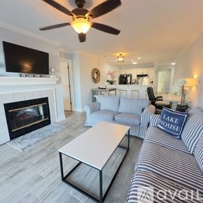 Cornelius condo for rent - A bedroom with a large bed and a ceiling fan.
