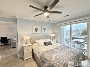 Cornelius condo for rent - A living room with a striped couch and a ceiling fan.