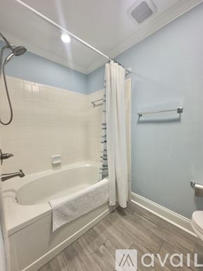 Cornelius condo for rent - A kitchen with a black refrigerator and white cabinets.