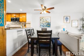 Imperial Beach condo for rent - A dining room with a wooden table and chairs.