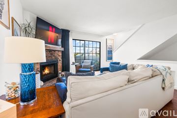 Imperial Beach condo for rent - A living room with a white couch and a fireplace.