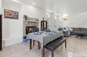San Diego house for rent - A dining room with a table set for two and a fireplace.