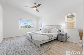 San Diego house for rent - A bedroom with a large bed and a ceiling fan.