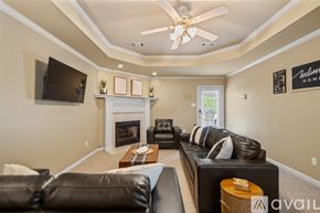 Sherwood house for rent - A living room with a fireplace and a flat screen TV mounted on the wall.