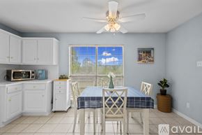Sherwood house for rent - A dining room with a table set for four.