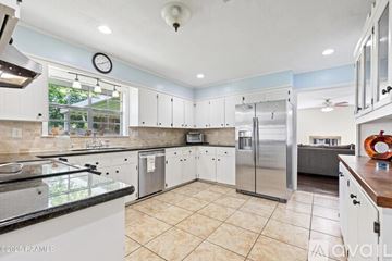 Lafayette house for rent - A kitchen with white cabinets and a tiled floor.