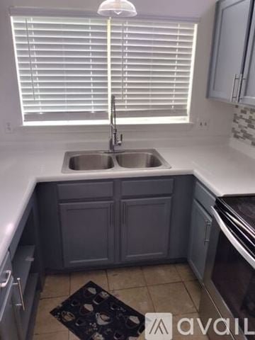 San Antonio house for rent - A kitchen with a sink and a window with blinds.