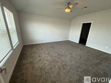 College Station house for rent - A kitchen with brown cabinets and white countertops.