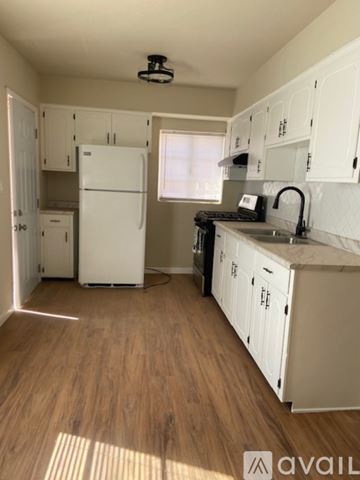El Paso apartment for rent - A kitchen with white appliances and wooden floors.