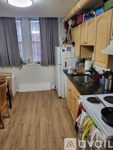Boston apartment for rent - A kitchen with wooden floors and a white refrigerator.