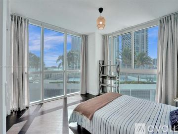 Boston apartment for rent - A bedroom with a large bed and a view of the outside.
