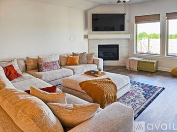 Fort Worth apartment for rent - A living room with a grey couch and a fireplace.