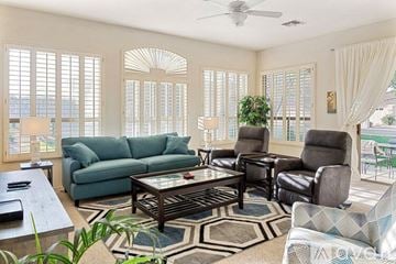 Sun Lakes house for rent - A living room with a glass table and a couch.