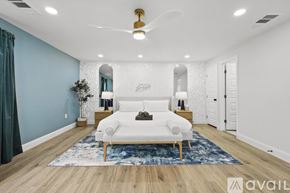 Irving house for rent - A spacious room with a white sofa and a blue rug.