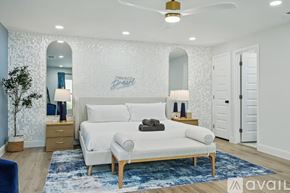 Irving house for rent - A bedroom with a white bed and a blue rug.