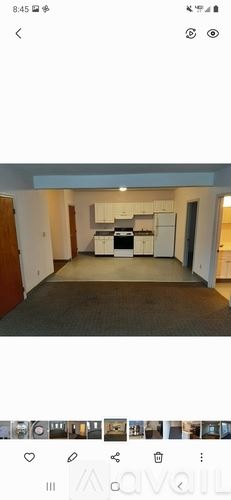 Lowell apartment for rent - A room with a kitchenette and a refrigerator.