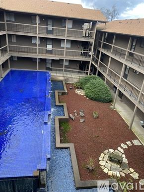 Salem apartment for rent - A blue tiled pool in the foreground of a balcony.