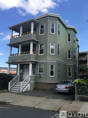 Somerville apartment for rent - A two-story house with a car parked in front.
