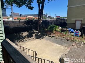 Somerville apartment for rent - A backyard with a tree and a fence.