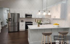 Crystal River house for rent - A modern kitchen with white cabinets and a central island.