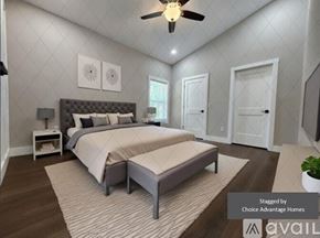 Crystal River house for rent - A bedroom with a large bed and a ceiling fan.