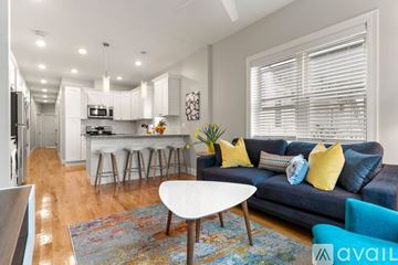 Boston apartment for rent - A living room with a blue couch and a white coffee table.