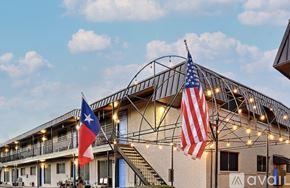 Sulphur Springs apartment for rent - A building with an American flag and a Chilean flag on flagpoles.