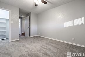 Sulphur Springs apartment for rent - A room with a carpeted floor and a ceiling fan.