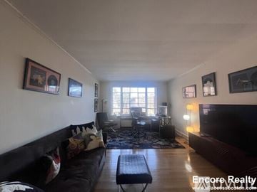 Brookline apartment for rent - A living room with a black couch and a coffee table.