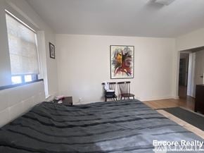 Brookline apartment for rent - A bedroom with a large bed and a painting on the wall.