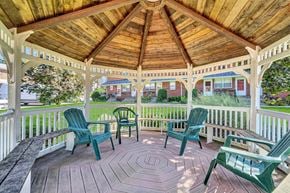 Marlton apartment for rent - A wooden gazebo with green chairs and a bench.