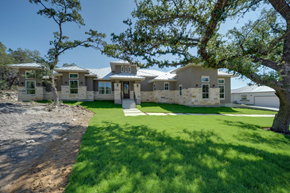 Spring Branch house for rent - A modern house with a green lawn and trees in the background.