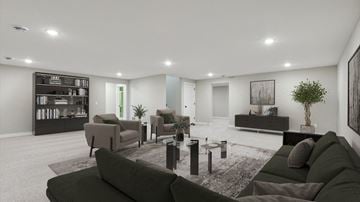 Hugo house for rent - A modern living room with a dark green sofa and a coffee table.