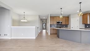 Hugo house for rent - A spacious kitchen with wooden cabinets and a white island.
