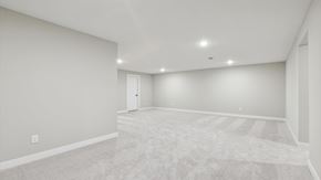 Hugo house for rent - A spacious room with a carpeted floor and white walls.