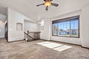 Sioux Falls house for rent - A spacious room with a ceiling fan and a large window.