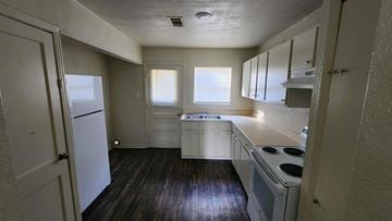 Killeen apartment for rent - A kitchen with white appliances and wooden floors.