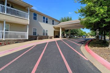 Fayetteville apartment for rent - A parking lot with red stripes in front of a building.
