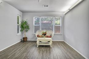 Fayetteville apartment for rent - A room with a white chair and a potted plant.