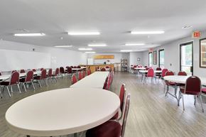 Fayetteville apartment for rent - A white table with red chairs in a room with a white wall and a yellow sign.