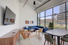 Chicago apartment for rent - A modern living room with a large window overlooking the city.