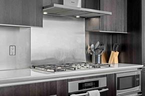 Calgary apartment for rent - A modern kitchen with a stove top and oven.