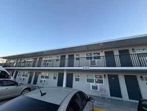 Fort Myers apartment for rent - A silver car is parked in front of a building with the number 2452 on it.
