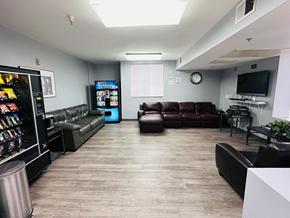 Fullerton apartment for rent - A living room with a couch, a television, and a vending machine.