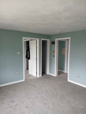 Johnston apartment for rent - A room with a carpeted floor and two open doors.