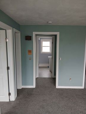 Johnston apartment for rent - A room with a carpeted floor and a doorway leading to another room.