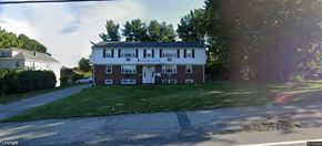 Johnston apartment for rent - A two-story brick house with a white door and windows.