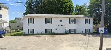 Johnston apartment for rent - A white two-story building with a black door and windows.
