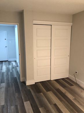 Halifax apartment for rent - A room with a white door and a wooden floor.