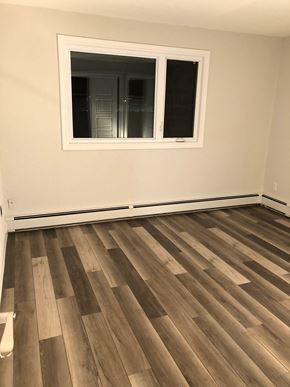 Halifax apartment for rent - A room with a window and wooden flooring.